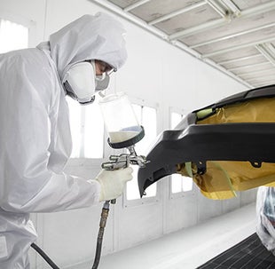Collision Center Technician Painting a Vehicle | Fitzgerald Toyota Chambersburg in Chambersburg PA