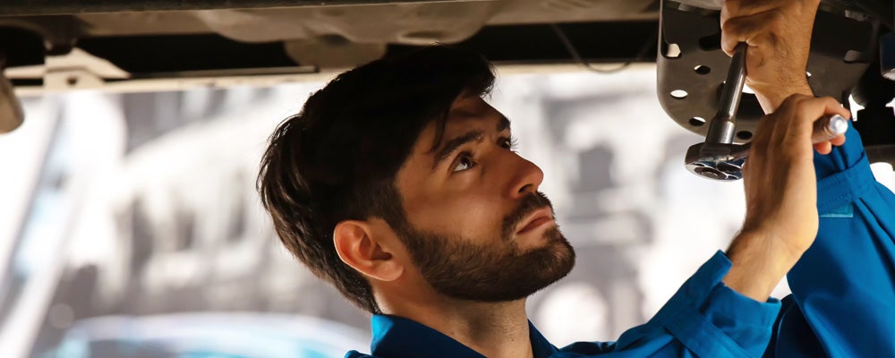 Mechanic working underneath car