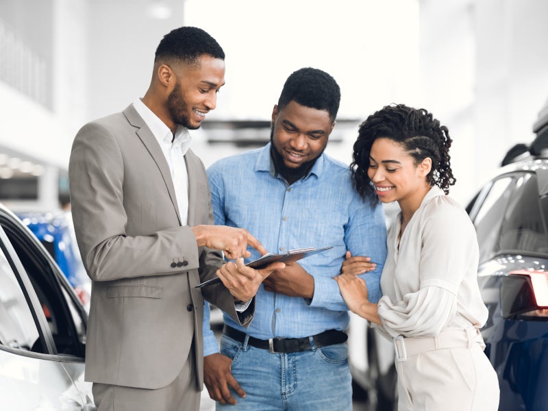 Couple looking at prices of cars