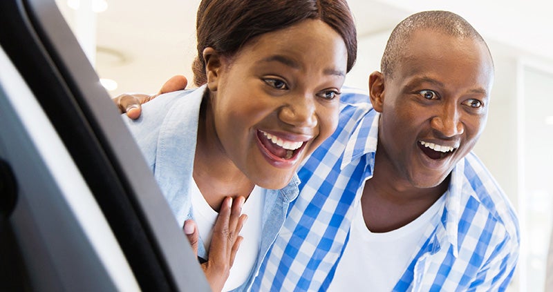 Couple looking at new car